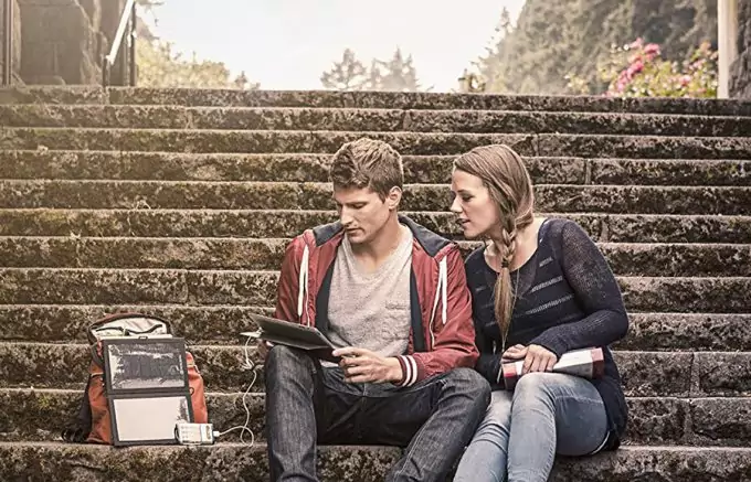 couple sitting next to solar charger