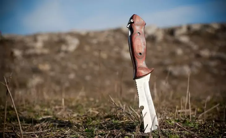 A survival knife in the ground