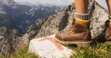 A woman wearing boots on a hilltop