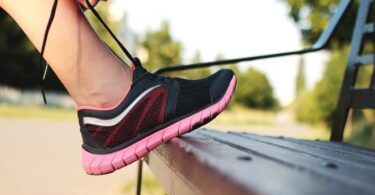 A running shoe being tied up