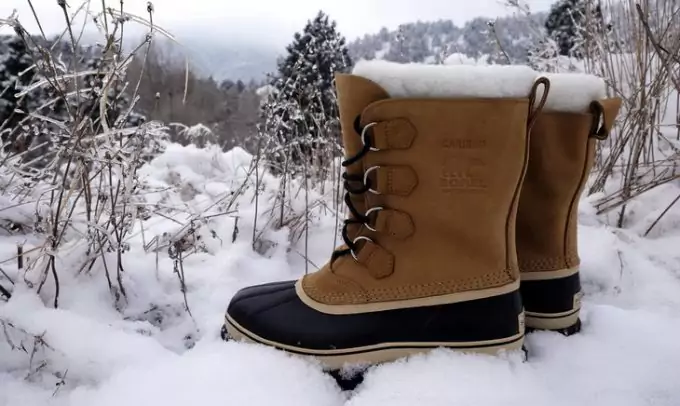 A pair of warm winter hiking boots in the snow