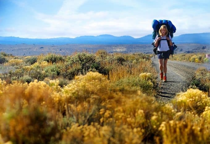 Women with hiking shoes and heavy backpack