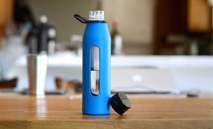 Blue water bottle on a wooden table in a house