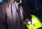 camper holding tactical flashlight