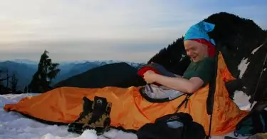 camper in winter sleeping bag