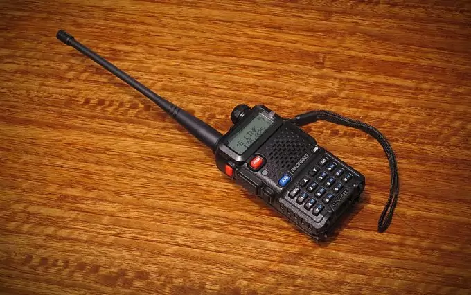 walkie talkie with a big antenna on desk 
