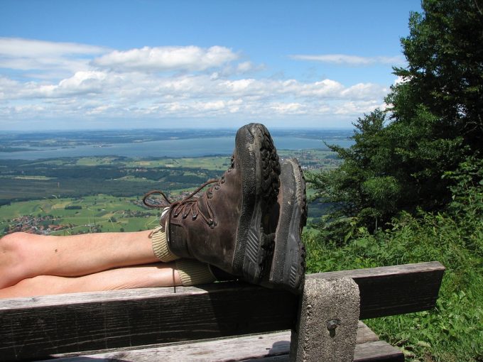 hiker resting his feet while wearing hiking shoes