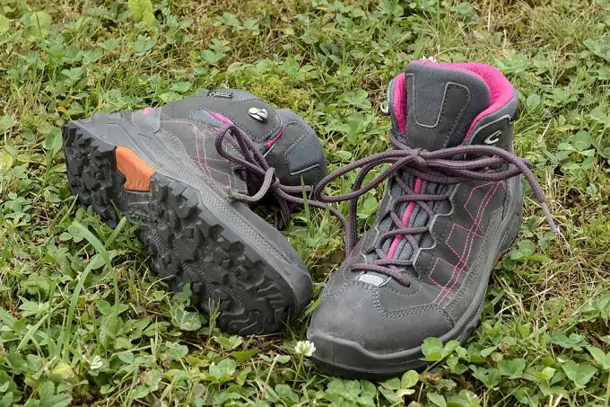 A pair of hiking shoes on the grass
