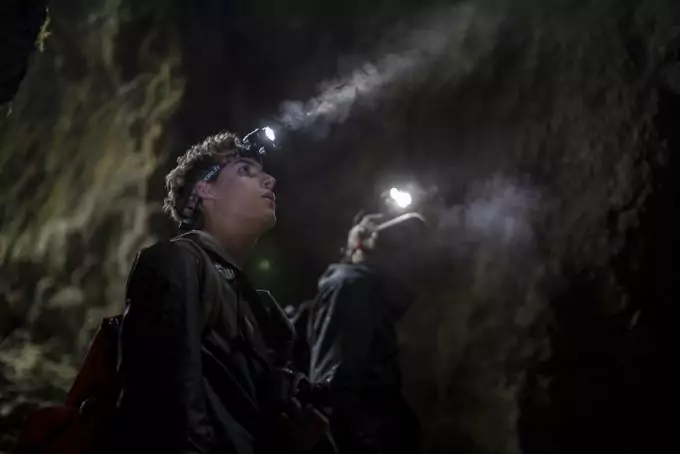 man with headlamp in cave
