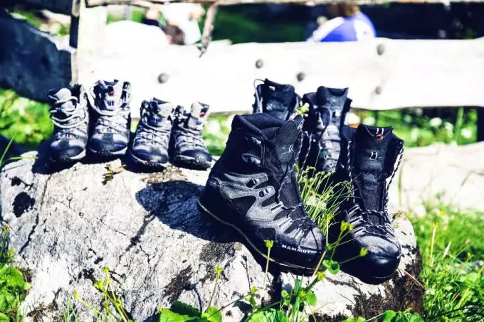 multiple pairs of hiking and backpacking boots in nature