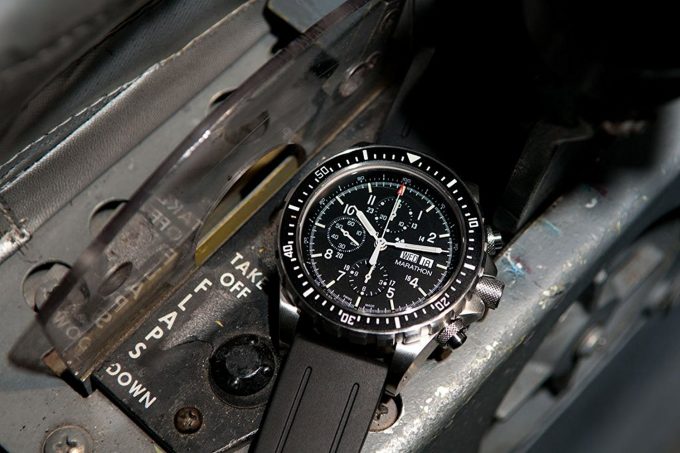 survival watch next to weapons