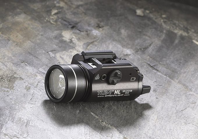 tactical flashlight on a rock