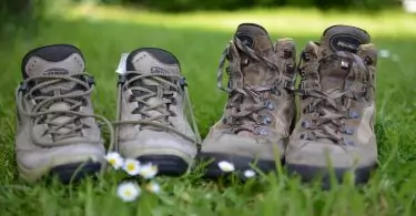 two pairs of hiking boots next to each other in nature