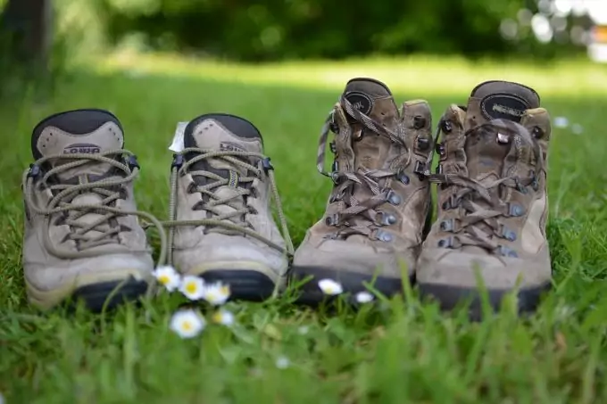 two pairs of hiking boots next to each other in nature