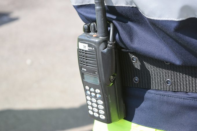 man wearing walkie talkie on belt