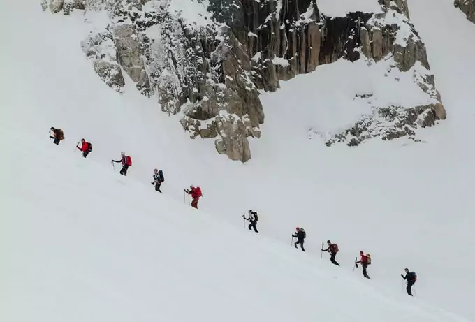 hiking with a group on snowy mountain