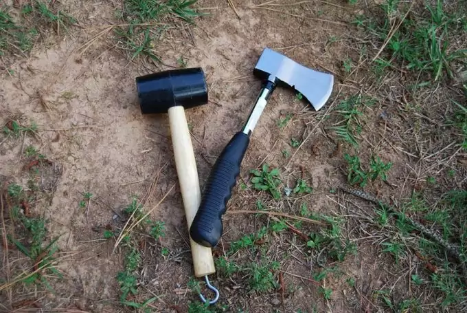 camping hatchet next to sledge hammer