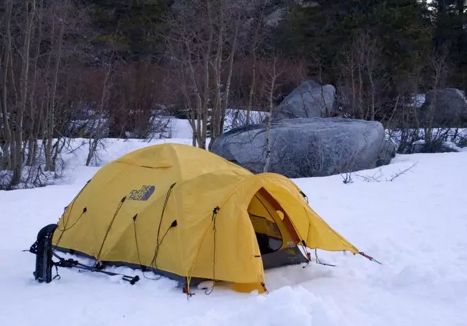 camping in tent in snowy conditions