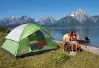 couple near lake with cheap tent