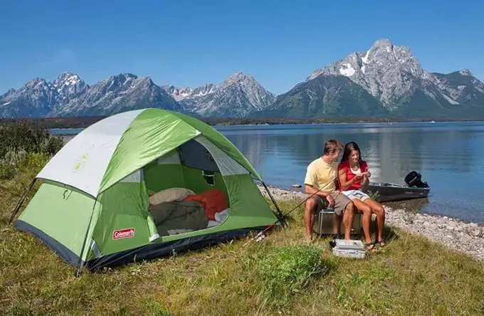 couple near lake with cheap tent