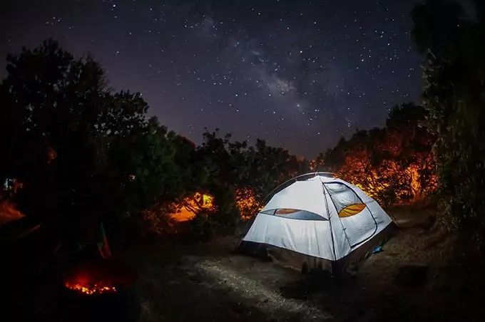 4 person camping tent lighted in the night