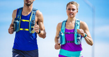 couple running wearing hydration bladders