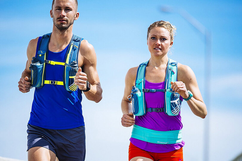 couple running wearing hydration bladders