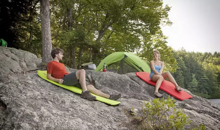 A couple relaxing on sleeping pads