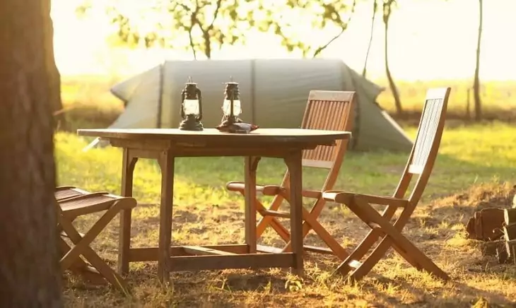 Image of a folding table and a tent in the background