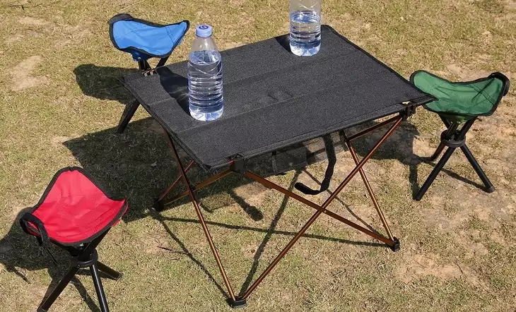 Camping-folding-table with two water bottles on it