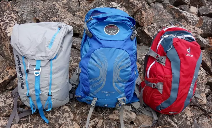 Three different types of daypacks on the ground