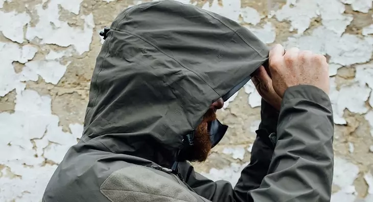 Side image of a man wearing a hardshell jacket