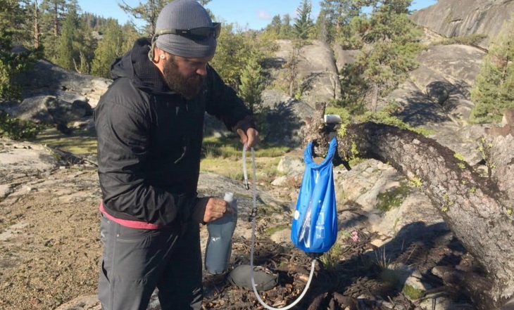 A man using a Gravity Water Filter