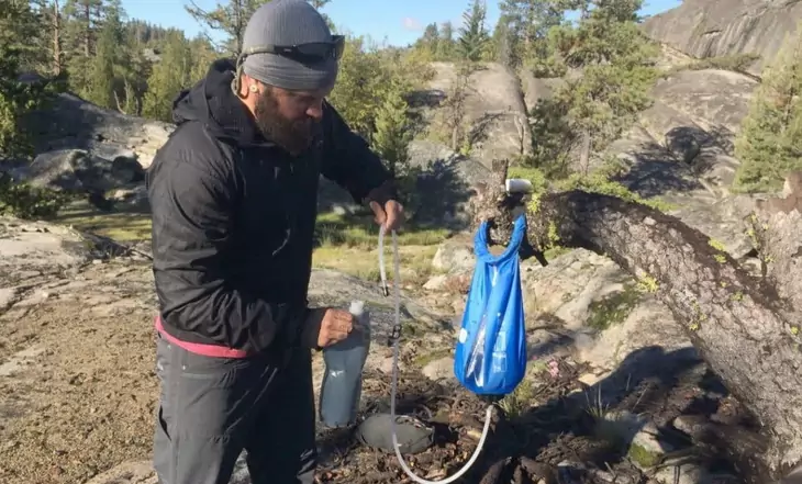 A man using a Gravity Water Filter