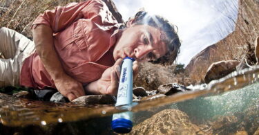 A man drinking water from the LifeStraw Water Purifier wich is the Lightest Backpacking Water Filter