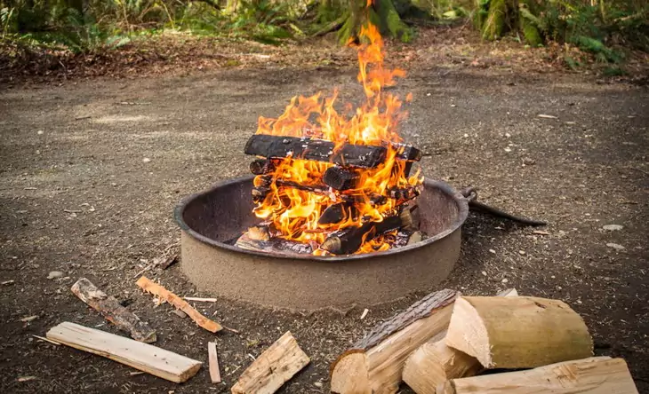 Image of a llog cabin campfire.
