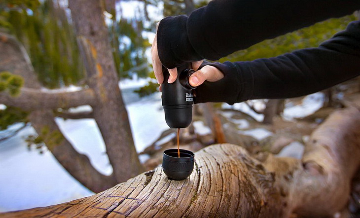 A man holding a Portable Espresso Maker