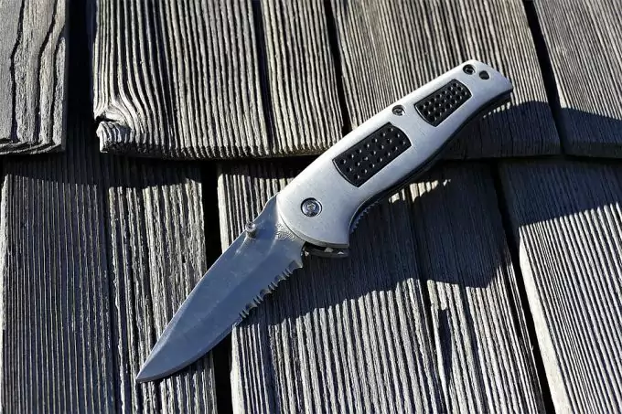 Sharp Metal folding Knife on table