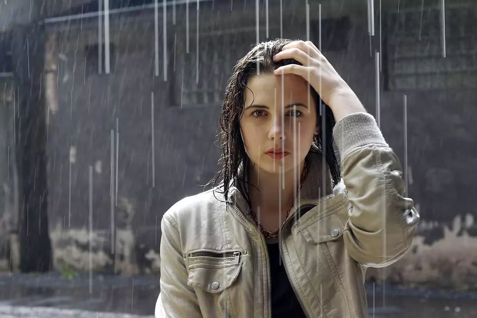 woman wearing a jacket standing in the rain
