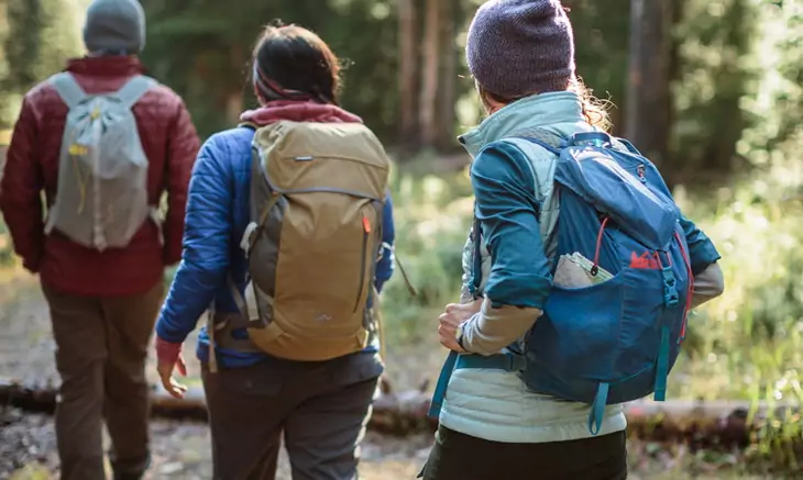 three hikers on the trail with their daypacks on