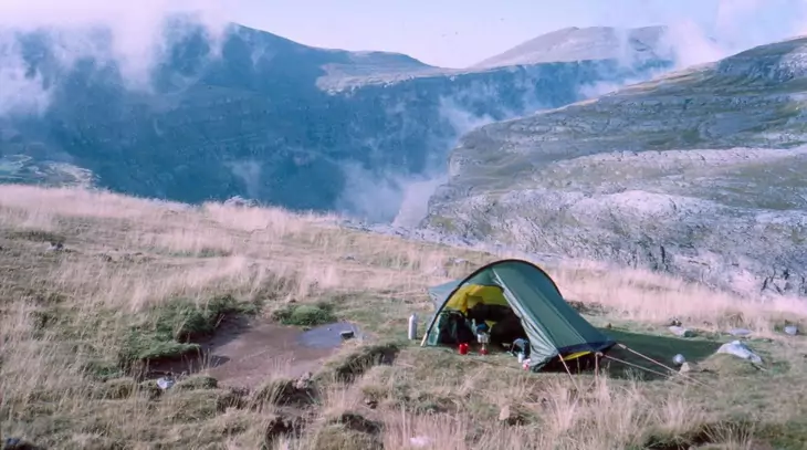 A solo tent in a mountain landscape