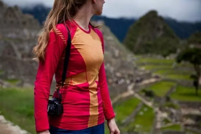A woman wearing Helly Hansen's HH Dry Revolution base layer while hiking