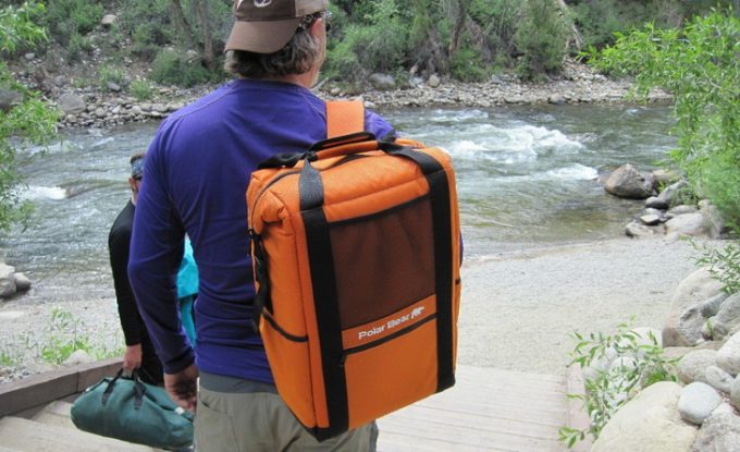 A man wearing a cooler backpack on his shoulder