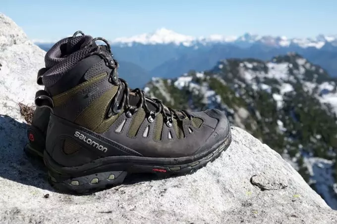 A pair of Hiking Boots and a moutain landscape