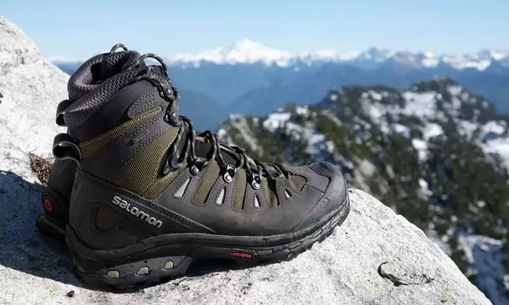 A pair of Hiking Boots and a beautiful landscape in the background