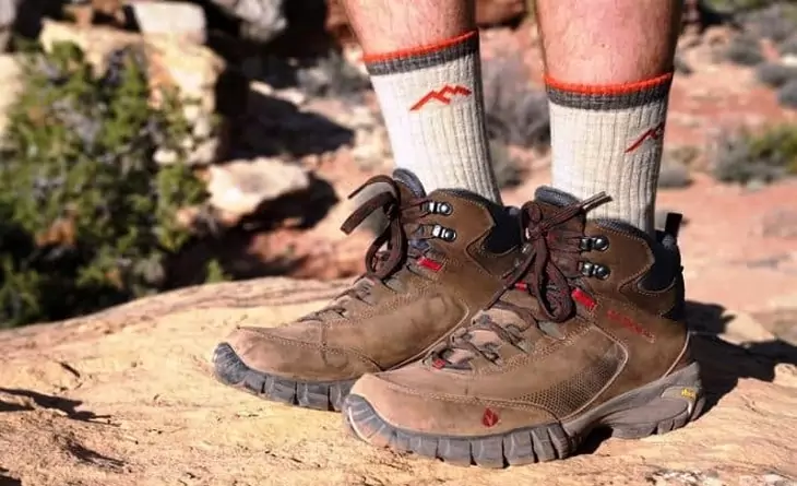 Hiker wearing warm socks with his boots