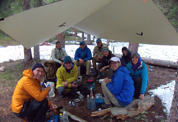 group of hikers under tarp