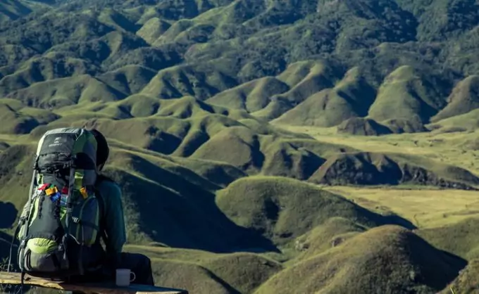 A backpacker getting rest on top of the mountain