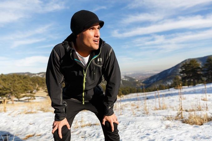 man wearing softshell jacket on snow mountain