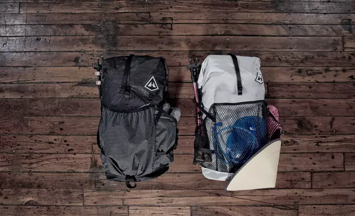 Two backpacks on a wooden floor
